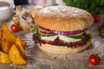 veggie burger with homemade cheese, tomato, cucumber and lettuce