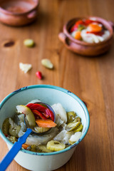 Mix of Turkish Pickles with green tomatoes, red pepper, cucumber and carrot in a bowl.