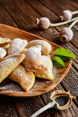 Sweet baked dumplings stuffed with poppy seeds and sprinkled with powdered sugar