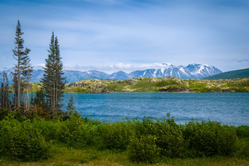 Lake in Frazer,  Canada with Snowcapped Mountains in Background 