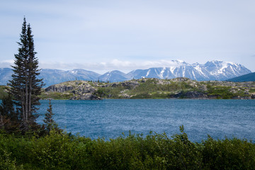 Lake in Frazer,  Canada with Snowcapped Mountains in Background 