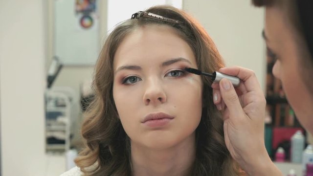 Makeup artist making make-up for a girl