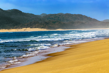 South Africa, KwaZulu-Natal province. iSimangaliso Wetland Park (Greater St. Lucia Wetlands Park, on UNESCO World Heritage Site) - sandy beach near St. Lucia town. Waves blur motion effect