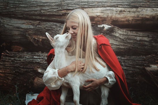 Funny Portrait Of Blond Woman And Her Goat