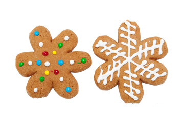 Snowflake shaped gingerbread cookies on white background