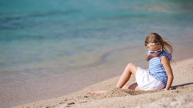 Adorable little girl at tropical beach during vacation