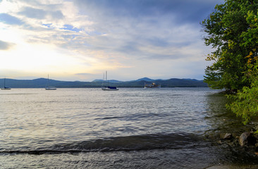 Lake George NY shore line and beach with multiple boats in after