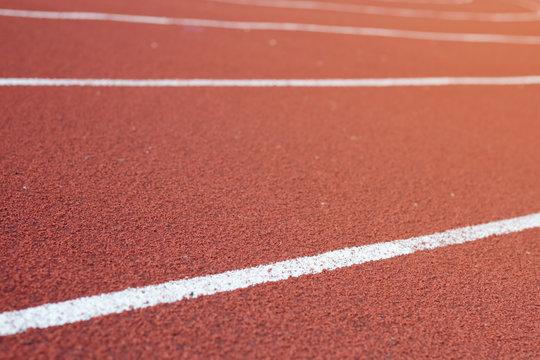 Running track around the football field with the evening sun