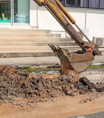 Excavator working on the Repair of  pipe water