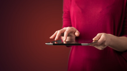 Close up of hand holding digital touchpad tablet device