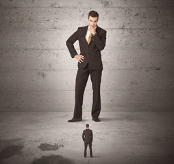 Obraz premium Huge business guy looking at small coworker