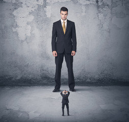 Obraz premium Big business bully looking at small coworker