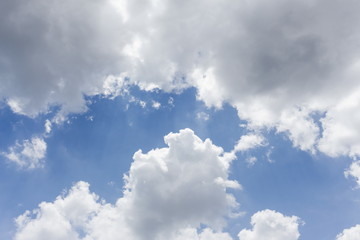 Blue sky is covered by white clouds and raincloud 