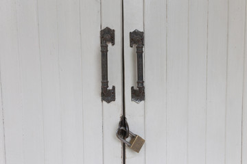 Old padlock on a white wooden door , Old White retro Door with Padlock, locked door,door with master key