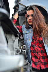Naklejka na ściany i meble long-haired brunette girl posing in a car scrappage