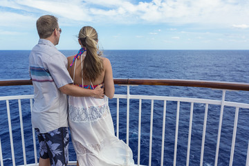 Happy Married Couple on a cruise together. Looking at their ocean view from a balcony while on a cruise ship vacation together © Brocreative