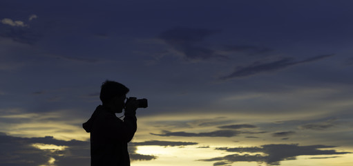 Photographer silhouette with blue sky sunset