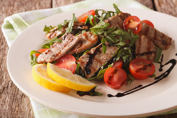 Straccetti salad with grilled beef, arugula and tomatoes close-up. Horizontal
