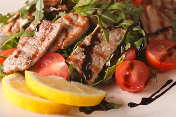 Fototapeta na wymiar Straccetti di manzo salad with beef, arugula and tomatoes macro. Horizontal 