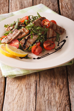 Straccetti&nbsp;salad with grilled beef, arugula and tomatoes close-up. vertical
