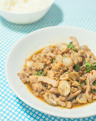 stir fried pork with basil and rice background