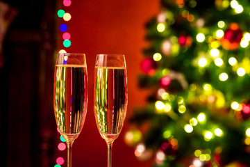 Two champagne glass on christmas bokeh background