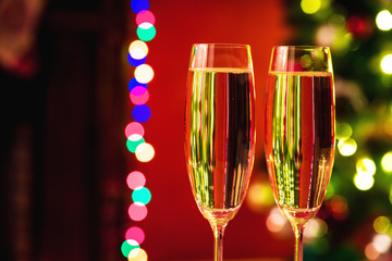 Two champagne glass on christmas bokeh background