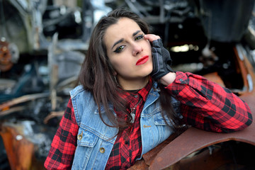 long-haired brunette girl posing in a car scrappage