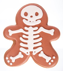 Funny beautiful delicious ginger biscuits Halloween in the form of a skeleton, isolated on white