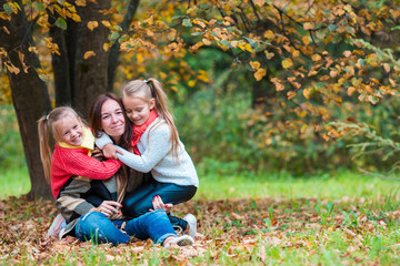 Happy family in autumn park outdoors