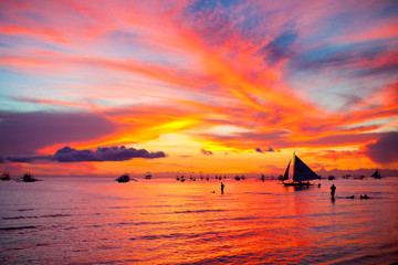 Sailing boat at beautiful colorful sunset