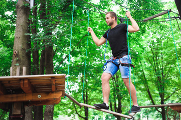 Hiking in the rope park beautiful sports guy