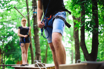 Fototapeta premium Hiking in the rope park two young people