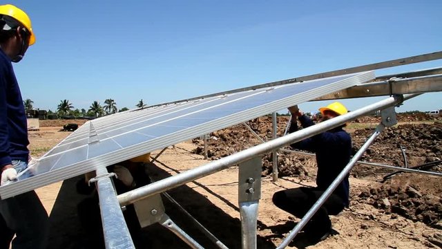 Time lapse shot of worker installing solar panels