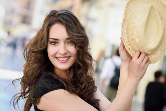 Beautiful Young Woman With Blue Eyes Smiling In Urban Background