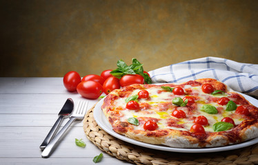 Pizza with mozzarella cherry tomatoes and basil