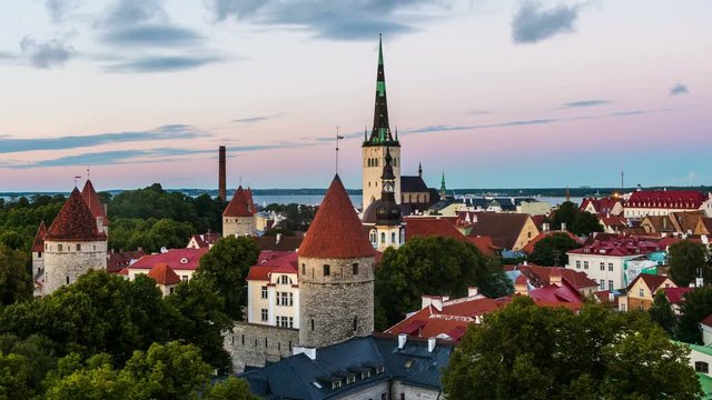 Aerial view of Tallinn, Estonia at sunset. Day to night time-lapse over old town.