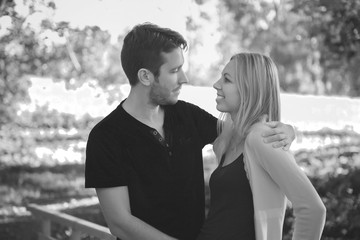 Happy couple in the park. Young man and woman. Black and white photo.