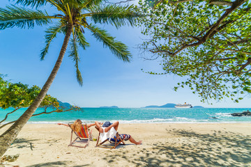 Couple on the beach at tropical resort Travel magazine