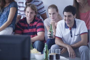 Friends watching sports match on television together