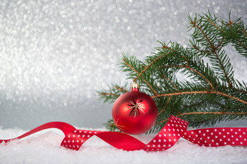 Christmas background with fir, red ball and ribbon