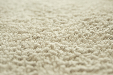 хлопковое махровое полотенце текстура. серая бежевая махровая ткань размытый фон