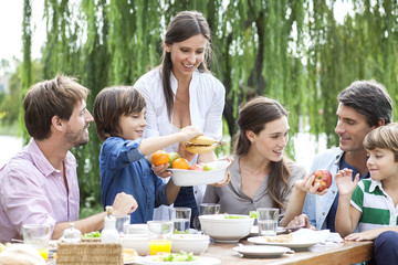 Family eating healthy meal together outdoors