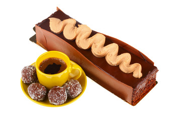 chocolate cake with cup of coffee and chocolate balls, isolated
