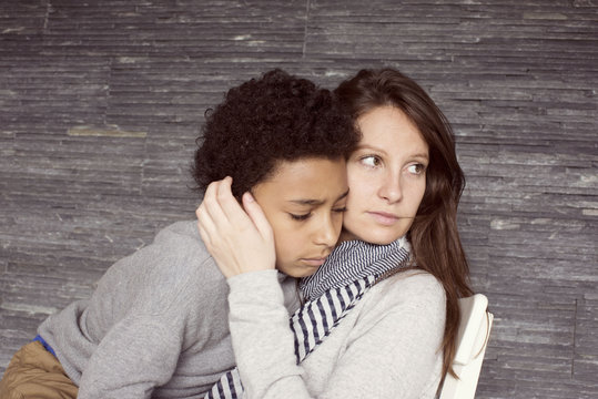 Mother and young son embracing