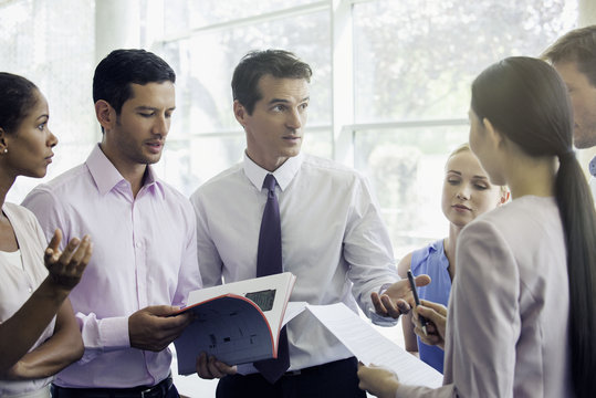 Business professionals collaborating in high pressure setting