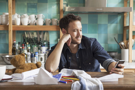 Man at home using smartphone