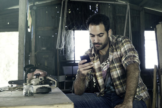Man browsing internet with smartphone during work break
