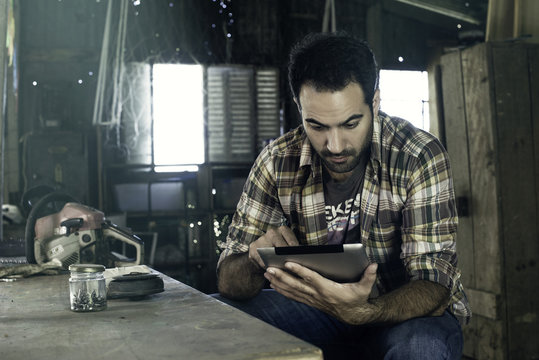 Man using digital tablet to access internet during break from work
