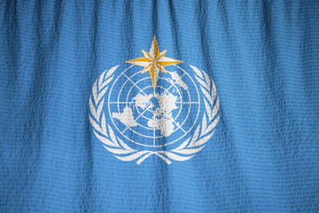Closeup of Ruffled World Meteorological Organization Flag, World - obrazy, fototapety, plakaty